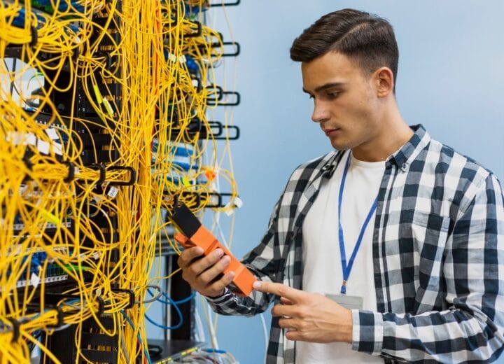 Young Man Looking Fiber Optic Tester Medium Shot 1
