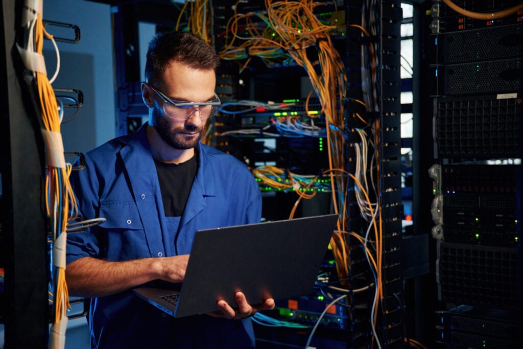 Glasses Young Man Is Working With Internet Equipment Wires Server Room
